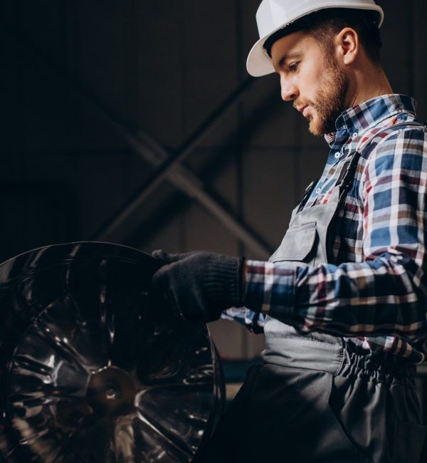 workman-wearing-hard-hat-working-with-metal-constructions-factory_1303-26647